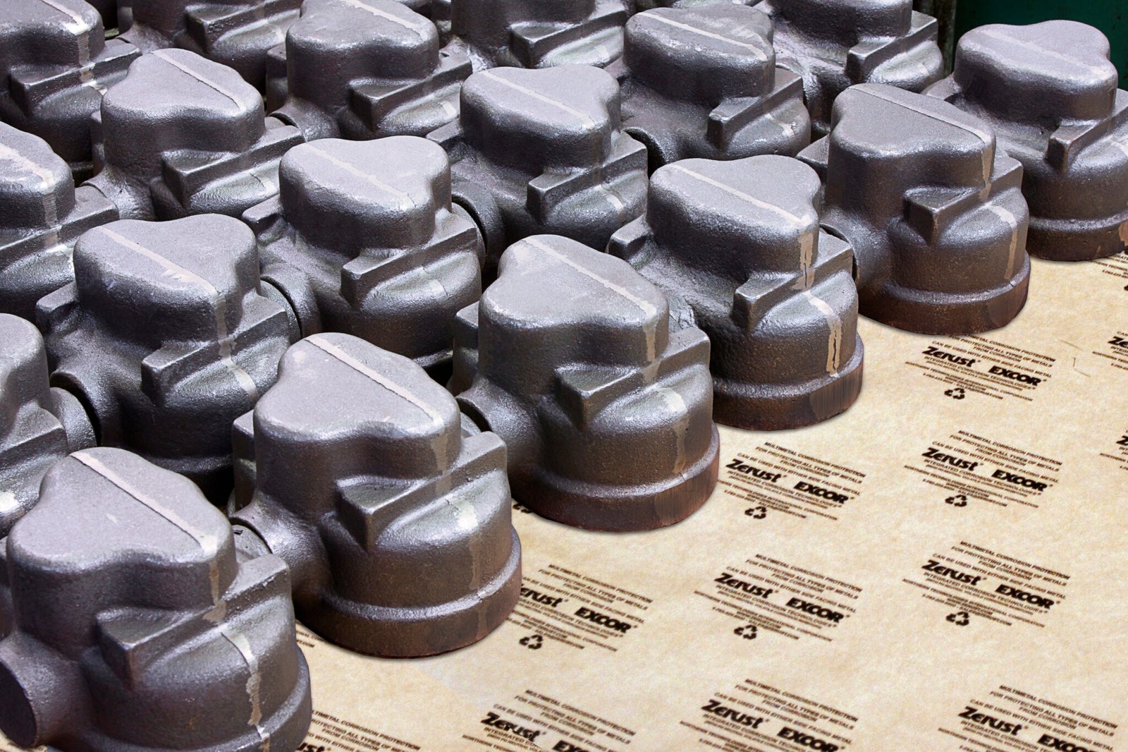 cast metal machine parts displayed in regular pattern